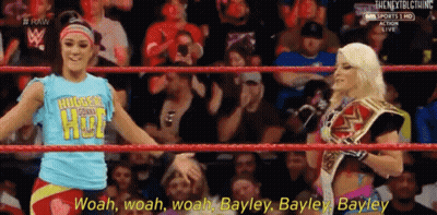 Two Women Standing Next To Each Other One Holding Championship Belt GIF