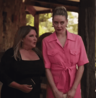 Two Women Standing Next To Each Other One In Pink Dress GIF