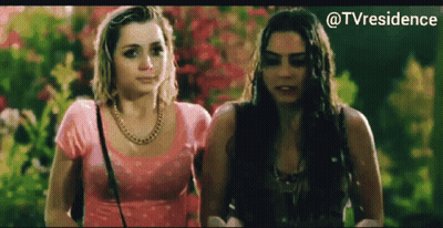 Two Women Standing Next To Each Other GIF