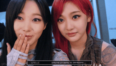 Two Women Standing Next To Each Other Saying Just The One Minion With The One Eye GIF
