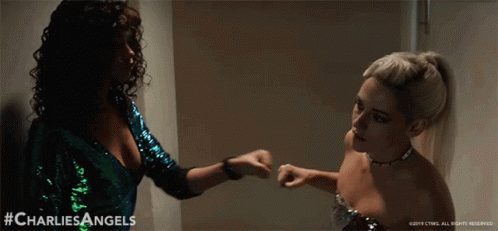 Two Women Standing Next To Each Other GIF