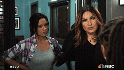 Two Women Standing Next To Each Other With The Nbc Logo On The Bottom Right GIF