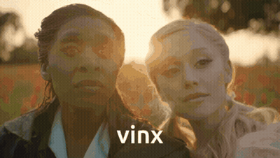 Two Women Standing Next To Each Other With The Word Vinx On The Bottom Right GIF