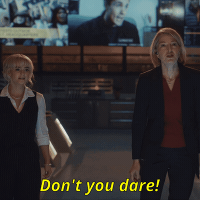 Two Women Standing Next To Each Other With The Words " Don 'T You Dare " In Yellow Letters GIF