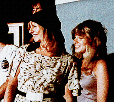 Two Women Standing Next To Number 1 GIF