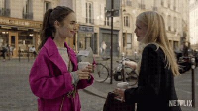 Two Women Standing On Street With Netflix Logo GIF