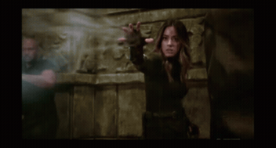 Two Women Standing One Holding Others Head GIF