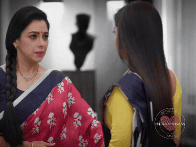 Two Women Standing, One In Yellow Blouse GIF