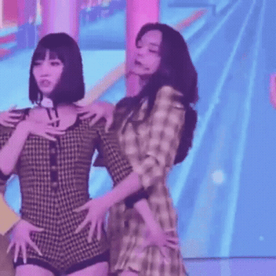 Two Women Standing Shoulder To Shoulder GIF