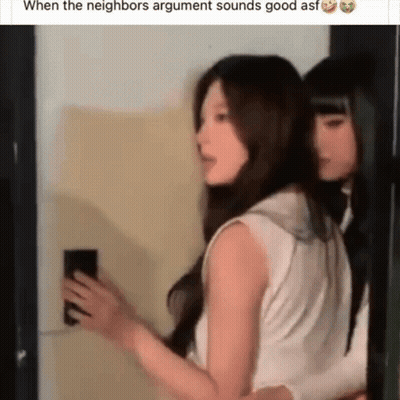 Two Women Standing Together One Holding Phone GIF