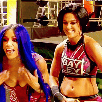 Two Women Standing Together One Wearing Bay Ley Shirt GIF