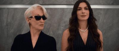 Two Women Standing Together One Wearing Sunglasses GIF