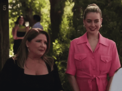 Two Women Standing Together With Number 5 GIF