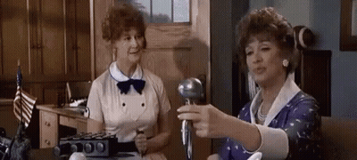 Two Women Standing With Microphone GIF