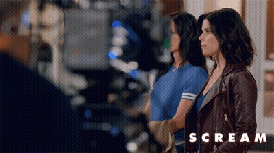 Two Women Standing With Scream Text GIF