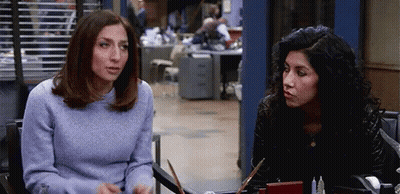 Two Women Talking At Table GIF