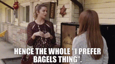 Two Women Talking In Front Of Building GIF
