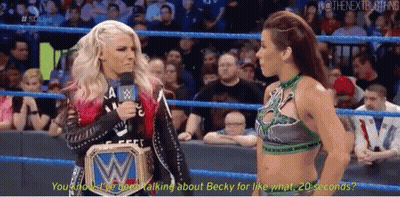 Two Women Talking In Wrestling Ring One Wearing WWE Belt GIF