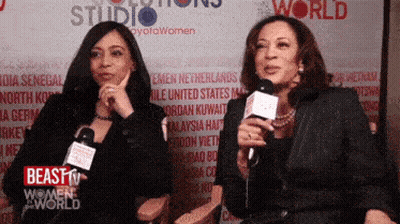 Two Women Talking Into Microphones Beast Women World GIF