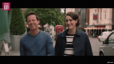 Two Women Talking On Sidewalk GIF