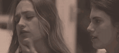 Two Women Touching Faces GIF