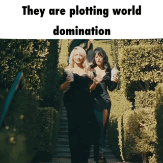 Two Women Walking Down Stairs With The Words They Are Plotting World Domination Below Them GIF