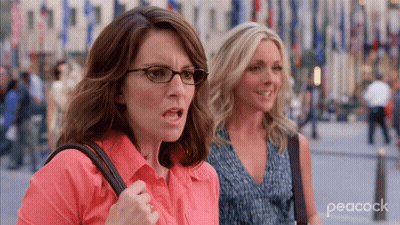 Two Women Walking Down Street With Peacock GIF
