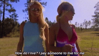 Two Women Walking In A Field With The Words How Do I Live I Pay Someone To Live For Me On The Bottom GIF