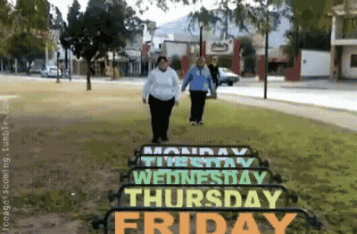Two Women Walking Past Monday Thursday And Friday Sign GIF