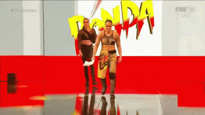 Two Women Walking Red Carpet Ronda Rousey Sign GIF