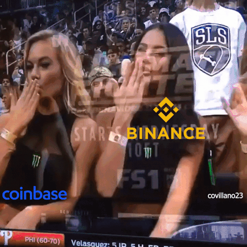 Two Women Watching Game With Binance On Screen GIF