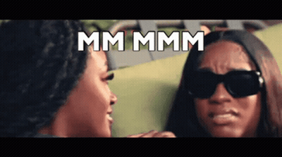 Two Women Wearing Sunglasses Are Looking At Each Other And The Words Mm Mmm Are Displayed Above Them GIF