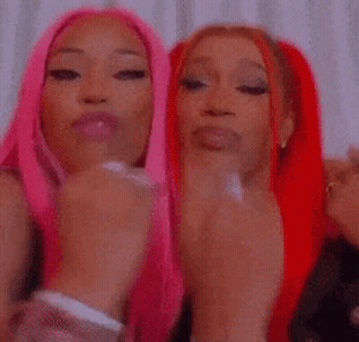 Two Women With Pink And Red Hair Covering Mouths GIF