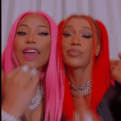 Two Women With Pink And Red Hair Posing GIF