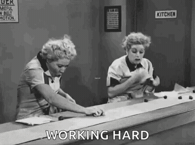 Two Women Working On Conveyor Belt GIF