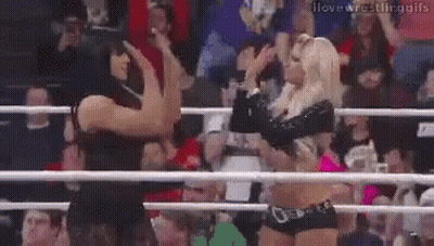 Two Women Wrestling In A Ring Holding Hands GIF