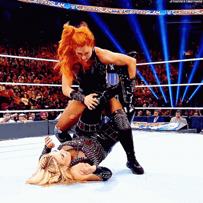 Two Women Wrestling In A Ring With A Banner That Says Summerslam On It GIF