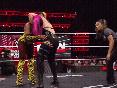 Two Women Wrestling In A Ring With The Word Saturn On The Wall Behind Them GIF
