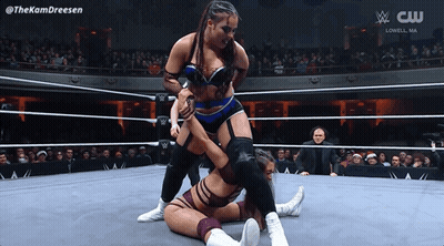 Two Women Wrestling In Ring With CW Logo GIF