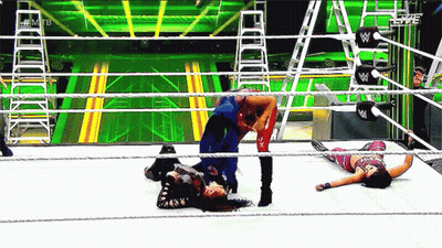 Two Women Wrestling in Ring With W Logo