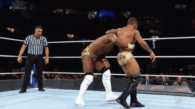 Two Wrestlers And Referee In Ring With 205 Live GIF