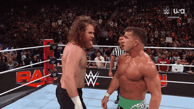 Two Wrestlers Are Facing Each Other In A Wrestling Ring With A Usa Logo Behind Them GIF