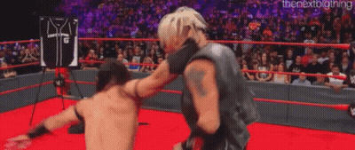 Two Wrestlers Are Fighting In A Wrestling Ring . GIF