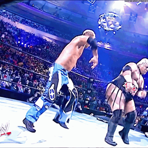 Two Wrestlers Are Fighting In A Wrestling Ring With A Watermark That Says ' Wwe ' On It GIF