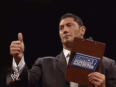 Two Wrestlers Are Giving A Thumbs Up In A Wrestling Ring . GIF