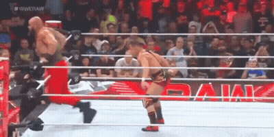 Two Wrestlers Are In A Wrestling Ring With A Banner That Says Wwe Raw GIF