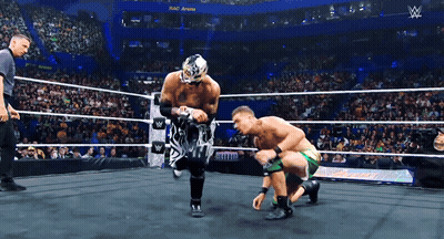 Two Wrestlers Are In A Wrestling Ring With A Sign That Says ' W ' On It GIF