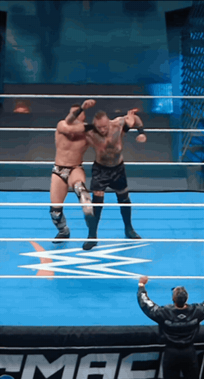 Two Wrestlers Are In A Wrestling Ring With The Word Mac In The Corner GIF