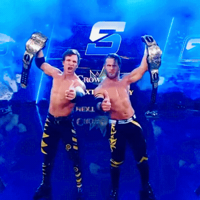 Two Wrestlers Are Posing In Front Of A Sign That Says Next GIF