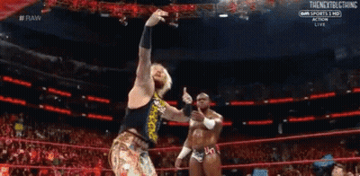 Two Wrestlers Are Standing In A Ring During A Match . GIF